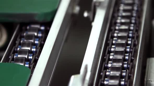 A Roller Conveyor Chain and Roller Conveyor Belt in a Factory.