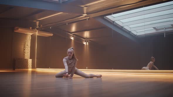 Young Female Dance in a Mirror Room with Light Lines Flexible Female Performs a Stretching Dance