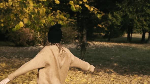 Carefree Female Teen Posing and Dancing in Autumn Park