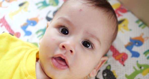 Infant Childhood Concept  Closeup of Smiling Happy Baby Plays with a Teether