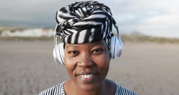 African woman talking on a video call while wearing headphones