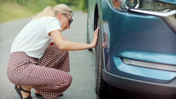 Woman Check Car Tire Pressure. Vehicle Trouble On Road On Vacation Trip. Female Trying Fix Car Tire.