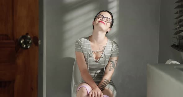 Slow Motion Woman on Toilet Smiling and Feeling Extreme Relief Urinating