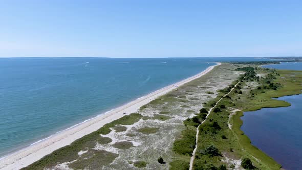 Aerial view of the ocean and the National Research Reserve , the view descends to a wooden footbridg