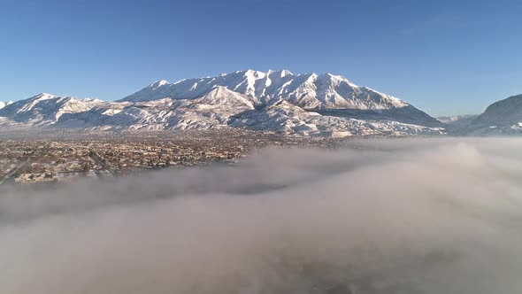 Aerial view of low fog over city in winter