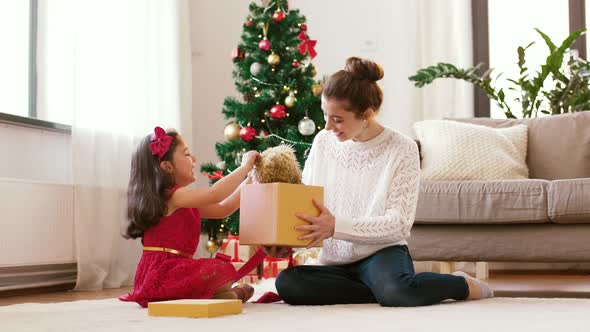 Mother and Daughter with Christmas Gift at Home