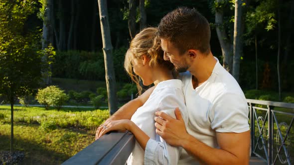 Guy and a Girl Hugging on a Bridge in the Beautiful Park