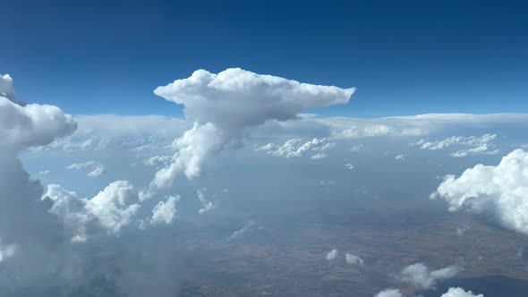 Awesome cockpit view. Pilot POV avoiding cumulus during the descend in a hazy atmosphere and a deep