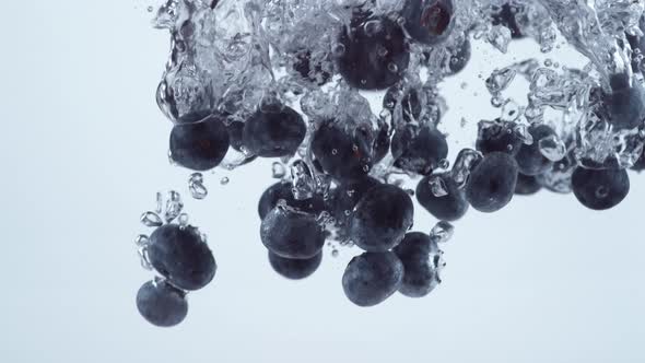 Slow motion shot of blueberries splashing into water, shot with Phantom Flex 4K camera.