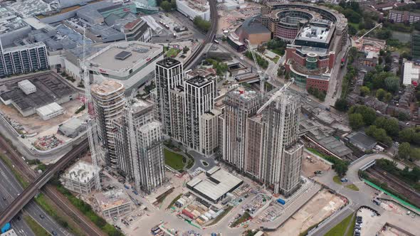 Slide and Pan Footage of Tower Cranes on Construction Site of Apartment Buildings Complex