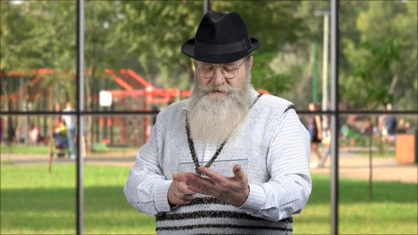 Old Bearded Man Using Glass Tablet Pc.