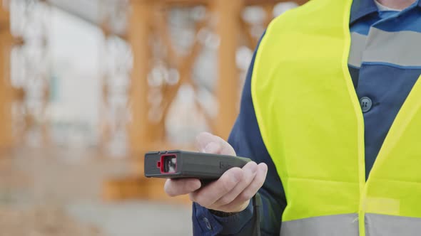 Engineer Using Measuring Device