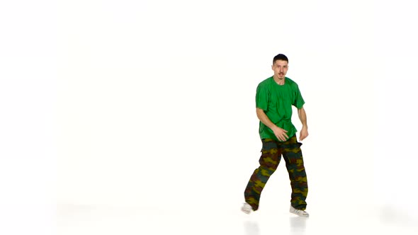 Talanted Young Dancer Man in Green Shirt Continue Dancing Breakdance on White