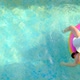 Summer time.Child swims in the swimming pool.Girl in a hat with a rainbow inflatable ring - VideoHive Item for Sale