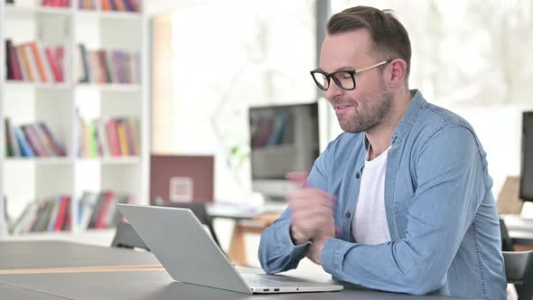 Online Video Chat on Laptop By Young Man