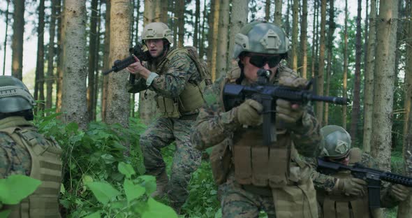 Fully Equipped Soldiers Wearing Camouflage Uniform Attacking Enemy