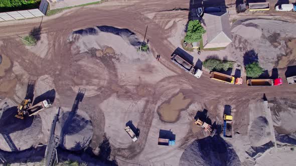 Excavator Loading Crushed Stone Into a Dump Truck in a Crushed Stone Quarry