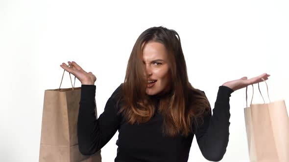 Positive human emotions. Pretty young woman with shopping bags after successful shopping