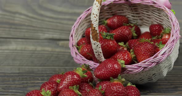 Strawberries in a Small Basket on the Wooden Table - Close Up