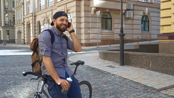 Cyclist Talks on the Phone on the Street