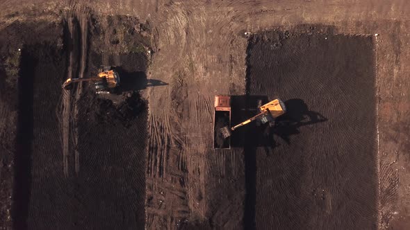 Drone Eye View of Construction Site with Machinery, Truck, Excavator.