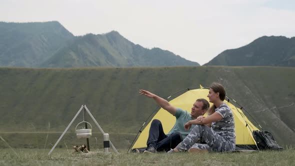 Loving Couple Relax in Nature in Front of the Tent in Sunny Weather