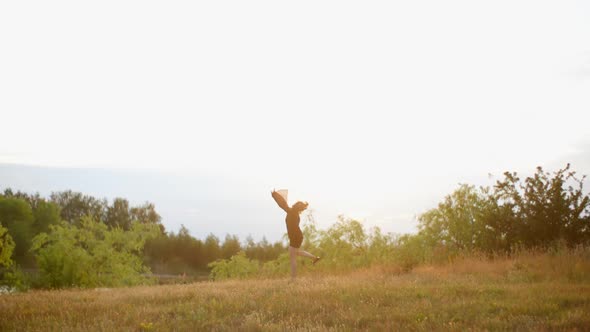 Young Model Jumping And Turning Around In The Meallow