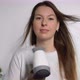 A Young Woman Dries Her Hair with an Electric Hair Dryer - VideoHive Item for Sale