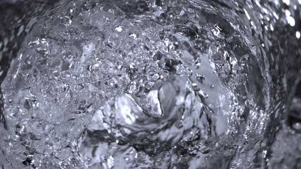 Super Slow Motion Shot of Water Whirling in Glass Bottle at 1000Fps