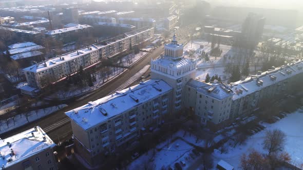 Building with Tower and Spire Near Avenue in Winter City