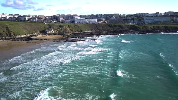 Amateur Surfers struggling to swim through waves. Wide drone-shot.