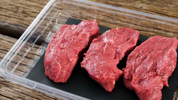 Beef steak in plastic container