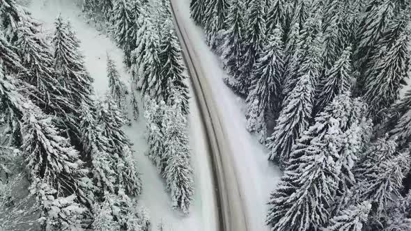 Aerial drone view of road in idyllic winter landscape.