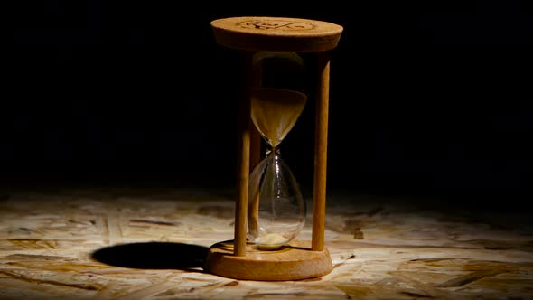 Grains of Sand Fall Down in the Hourglass. Spot Light