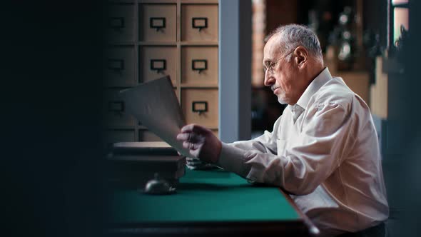 Confident Elderly Business Male Working Paper Documents Checking Payment Bills Counting Earnings