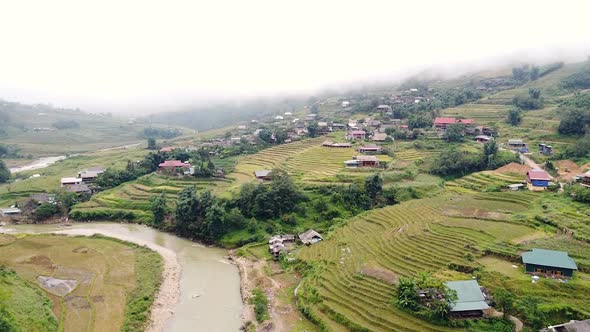 Aerial View of Hmong Village in Sapa Vietnam with Rice Terraces on a Foggy Day.
