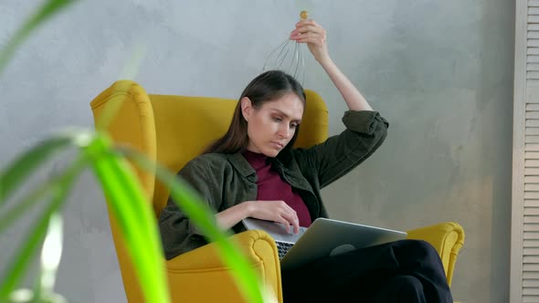 Woman relaxes with head massager. in modern interior.