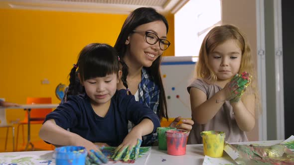 Teacher Developing Creativity of Kids at Art Class