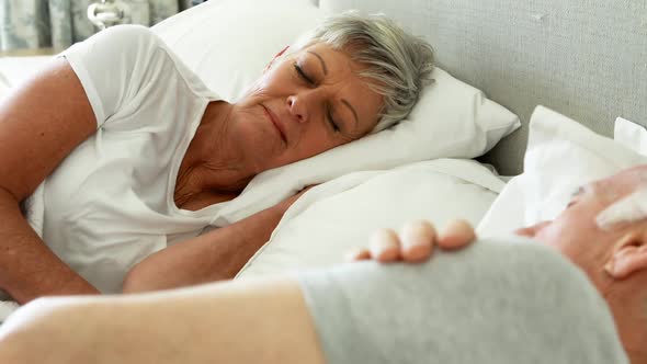 Senior couple sleeping in the bedroom