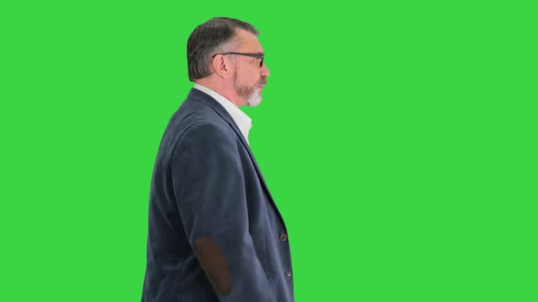 Smart Business Man in Glasses Looking at Watch and Walking Quickly Being Late on a Green Screen