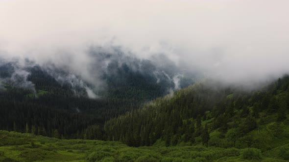 Beautiful Aerial Landscape Above Mountains after rain. Drone Flying over Clouds