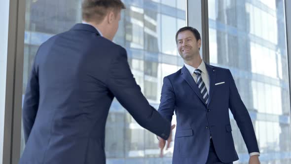 Cheerful Middle Aged Businessmen Shaking There Hands in Boardroom