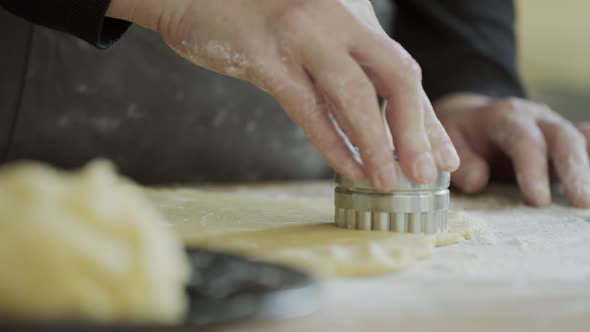 Woman making filled Christmas cookies