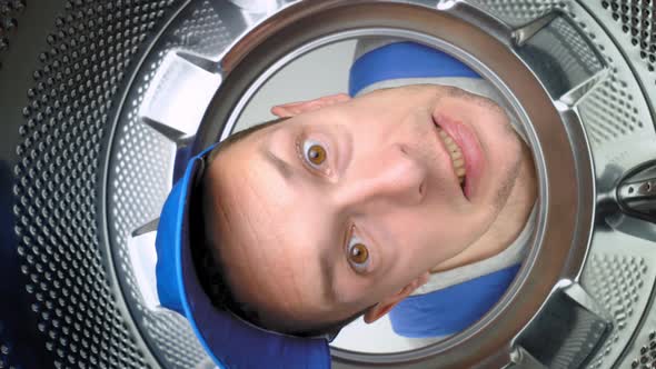 home appliance repairman sticks his head in drum of washing machine and screams