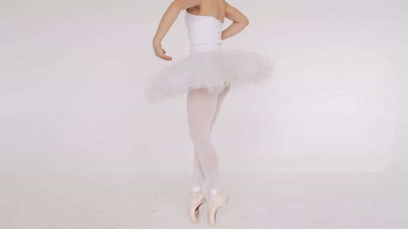 Woman Dancing Gracefully in Ballet Studio