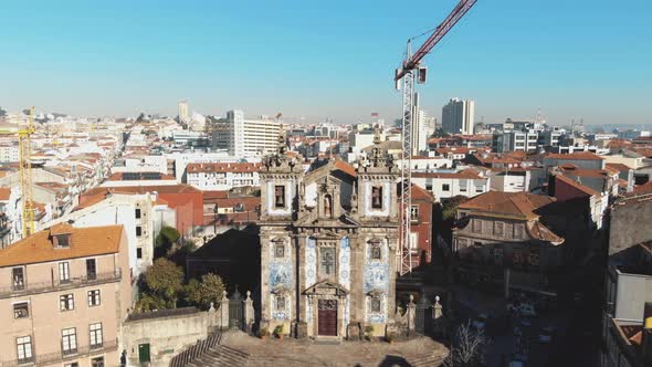 Church of Saint Ildefonso near Batalha Square in Oporto, Portugal - Pull back ascend aerial shot