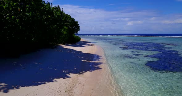 Beautiful flying copy space shot of a summer white paradise sand beach and aqua blue ocean backgroun