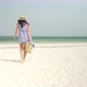 Young Woman Walks Barefoot On Beach Towards Ocean - VideoHive Item for Sale