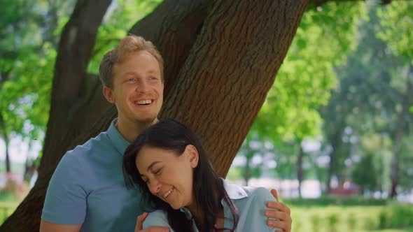 Portrait of Laughing Couple on Sunny Park
