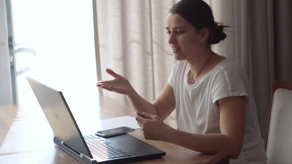 Authentic Caucasian Young Woman Chatting On Laptop At Home In Living Room